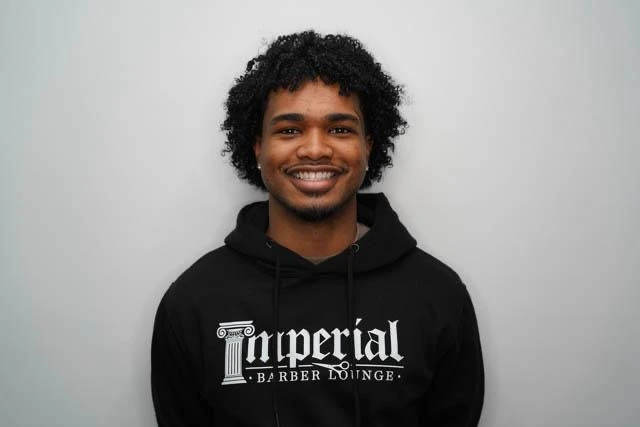 Headshot of Korti, barber at imperial barber lounge