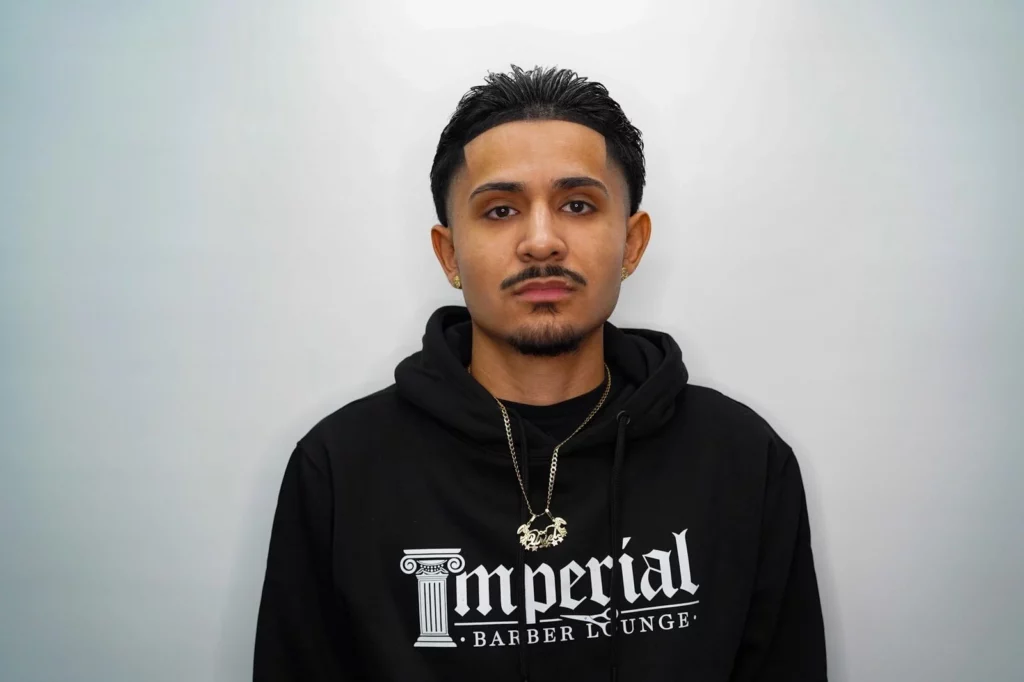 Headshot of Uriel, a barber of Imperial Barber Lounge's St. Paul location