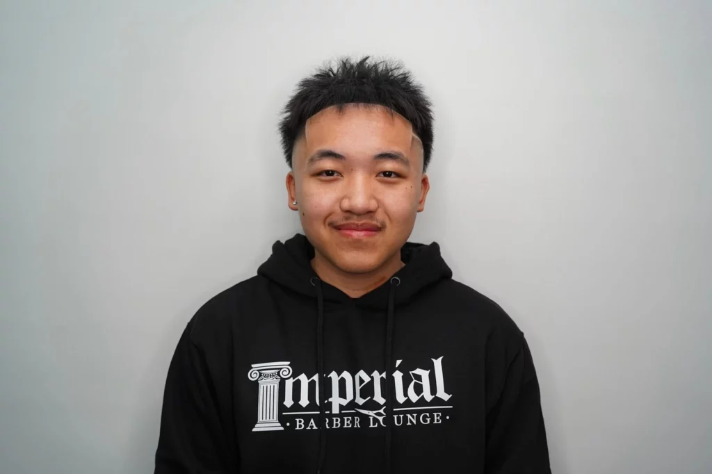 Headshot of Zk, barber at imperial barber lounge